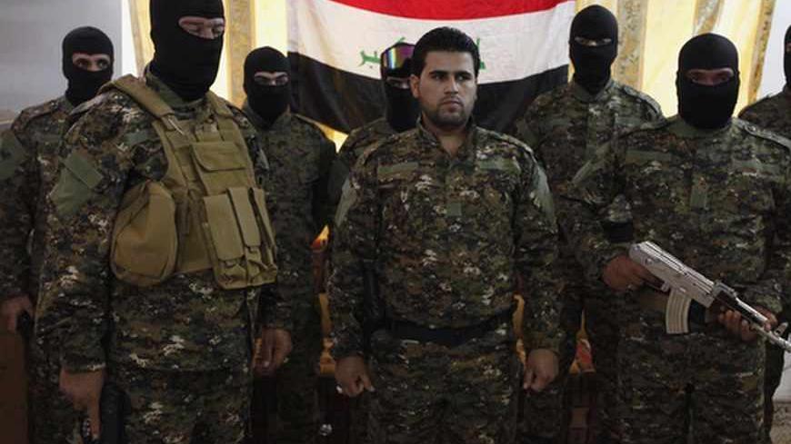 Fighters from Iraq's Islamist Shi'ite militias pose for pictures before departing to Syria from Baghdad, June 11, 2013. Syria is splintering the Middle East along a divide between the two main denominations of Islam, becoming a battlefield in a proxy war between Assad's main regional ally, Shi'ite Iran, and his Sunni enemies in Turkey and the Gulf Arab states. As the Syrian war grinds into its third year, sectarian killings are increasing, while hardline Sunni clerics are declaring Jihad or holy war on the 