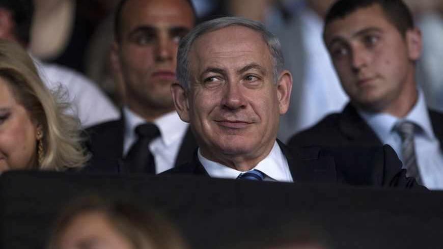Israel's Prime Minister Benjamin Netanyahu smiles during the opening ceremony of the 19th Maccabiah Games at Teddy Stadium in Jerusalem July 18, 2013. The quadrennial games brings together some 9,000 Jewish athletes from 78 countries for 12 days of sporting events and competitions. REUTERS/Baz Ratner (JERUSALEM - Tags: POLITICS SPORT HEADSHOT) - RTX11R7V