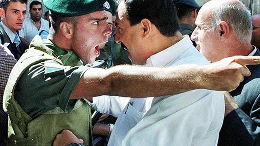 An Israeli Border Policeman and a Palestinian scream at each other face to face in the Old City of Jerusalem October 13, 2000 as the Palestinian is refused entry to the al-Aqsa mosque for Friday prayers. Israeli security forces prevented thousands of Palestinians from attending Friday prayers over concern for continued unrest and clashes following the prayers due to the increased tensions and fighting in the West Bank and Gaza Strip.  REUTERS/Amit Shabi 

JWH/WS/FMS - RTRBSE2