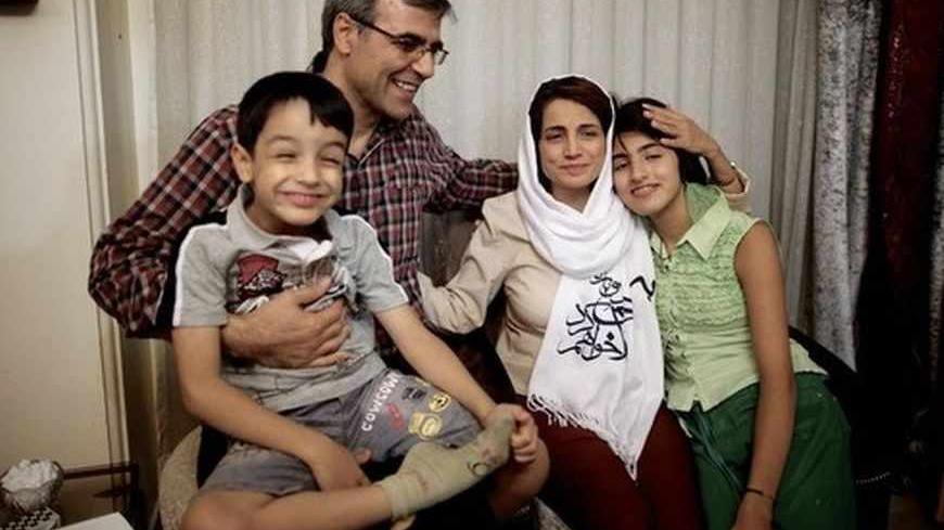 Iranian lawyer Nasrin Sotoudeh poses with her husband, Reza Khandan, her son Nima (L) and her Daughter Mehraveh (R) at herat her home in Tehran on September 18, 2013, after being freed following three years in prison. Sotoudeh told AFP she was in "good" physical and psychological condition, and pledged to continue her human rights work. Her release came a week before Irans new moderate President Hassan Rowhani, who has promised more freedoms at home and constructive engagement with the world, travels to New