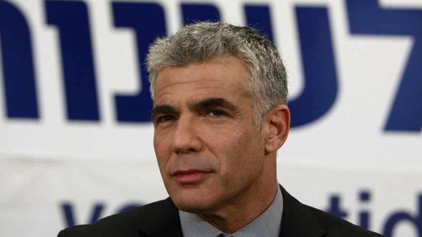 Yair Lapid, leader of the Yesh Atid (There's a Future) party, pauses while addressing supporters at his party's headquarters in Tel Aviv January 23, 2013. Lapid, a former television news anchor whose new centrist party stormed to second place in Israel's election, may well be the kingmaker holding the keys to the next coalition government. REUTERS/Ammar Awad (ISRAEL - Tags: POLITICS ELECTIONS PROFILE HEADSHOT) - RTR3CU5L