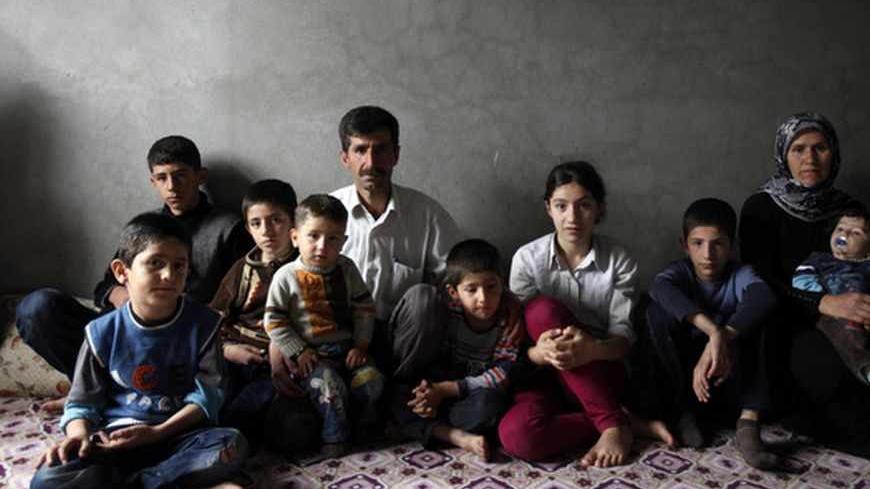 Members of the Savun family pose in their home in town of Cizre in Sirnak province, near the border with Syria March 23, 2013. Turkey's fledgling peace process with the Kurdistan Workers Party (PKK) militant group is all over the headlines. After three decades of war, 40,000 deaths and a devastating impact on the local economy, everybody seems ready for peace. Pro-Kurdish politicians are focused on boosting minority rights and stronger local government for the Kurds, who make up about 20 percent of Turkey's