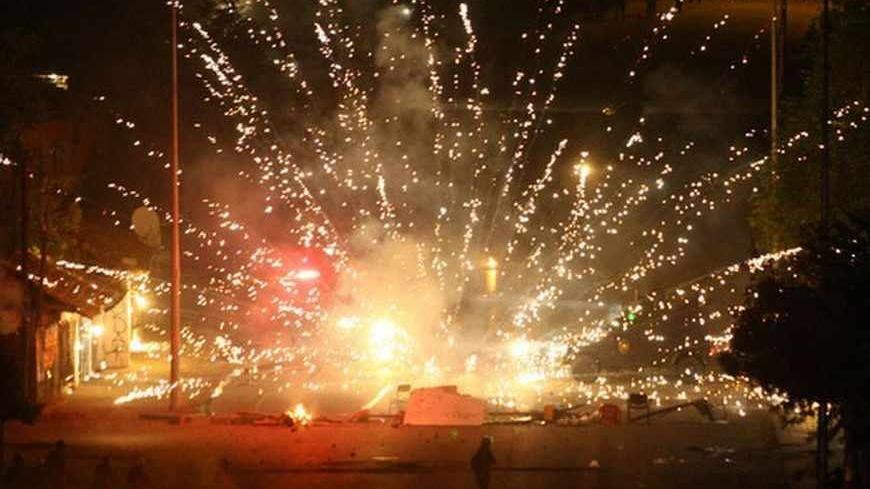 Turkish riot police are targeted with fireworks during a protest against a government project, the first ever cultural center containing an Alevi cemevi and a Sunni mosque side by side, in Tuzlucayir neighborhood of Ankara, on September 12, 2013 AFP PHOTO/ADEM ALTAN        (Photo credit should read ADEM ALTAN/AFP/Getty Images)