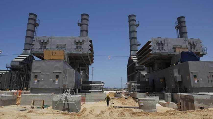 A labourer works at the construction site of Dorad, a private power plant in the southern city of Ashkelon May 17, 2012. Israel Electric Corp (IEC), which is responsible for nearly every aspect of electricity from running power plants to connecting households, simply cannot keep up with growing demand.The state-owned utility just lost natural gas supplies from neighbouring Egypt and fuel costs are soaring. Reserves are low and capacity insufficient and the government, under pressure from massive cost-of-liv