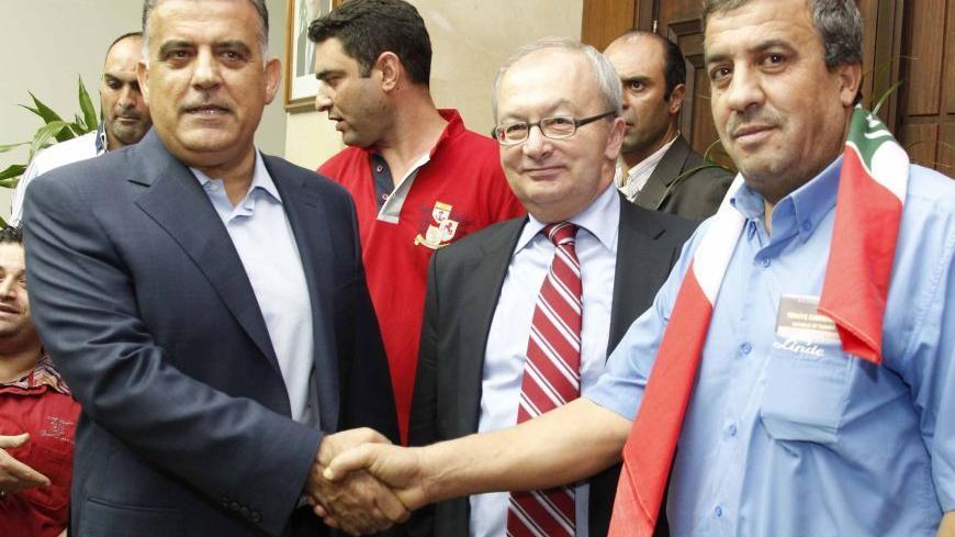 Newly released Abdulbasit Aslan (R), a Turkish national abducted by a Lebanese Shi'ite in Beirut, shakes hands with Abbas Ibrahim, head of the Lebanese General Security, as Turkish ambassador to Lebanon Inan Ozyildiz (C) looks on, at the Lebanese General Security headquarters in Beirut September 13, 2012.  REUTERS/ Mohamed Azakir        (LEBANON - Tags: CIVIL UNREST POLITICS) - RTR37XTM