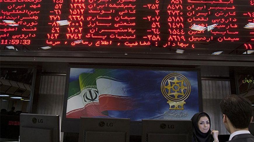 EDITORS' NOTE: Reuters and other foreign media are subject to Iranian restrictions on their ability to report, film or take pictures in Tehran. 

A trader speaks with a stock market official beneath the electronic board at the Tehran stock exchange September 15, 2010. While U.S. diplomats were busy upping Iran's economic punishment over nuclear activities Washington fears are aimed at making a bomb, Iranian shares, which might have been expected to fall, have, instead, gone through the roof. Picture taken S