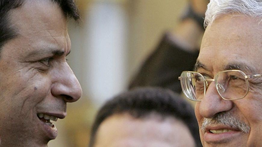 Palestinian President Mahmoud Abbas (R) talks to senior Fatah official Mohammad Dahlan after his meeting with Egypt's President Hosni Mubarak (not pictured) in Cairo February 10 2007.   REUTERS/Tara Todras-Whitehill (EGYPT) - RTR1M950