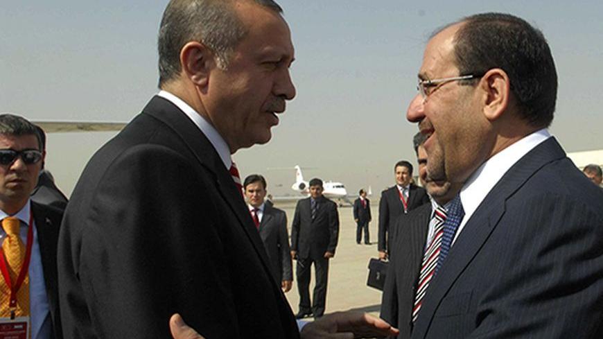 Iraq's Prime Minister Nuri al-Maliki (R) welcomes his Turkish counterpart Recep Tayyip Erdogan at Baghdad International Airport, October 15, 2009.  REUTERS/Iraqi Government/Handout (IRAQ POLITICS) - RTXPNTX