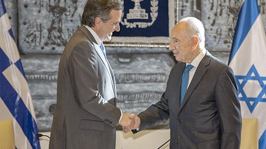 Israel's President Shimon Peres (R) shakes hands with Greece's Prime Minister Antonis Samaras during their meeting in Jerusalem October 8, 2013. REUTERS/Baz Ratner (JERUSALEM - Tags: POLITICS) - RTX143VM