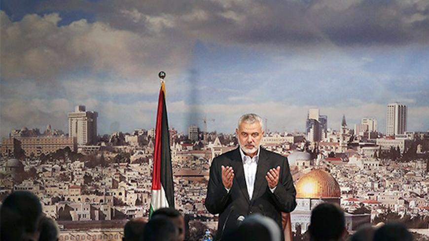 Ismail Haniyeh, prime minister of the Hamas Gaza government, prays before delivering a speech in Gaza City October 19, 2013. Haniyeh urged rival Palestinian President Mahmoud Abbas to speed up the implementation of the faltering Egyptian-brokered unity deal to heal six years of political rifts. REUTERS/Mohammed Salem (GAZA - Tags: POLITICS) - RTX14GN2