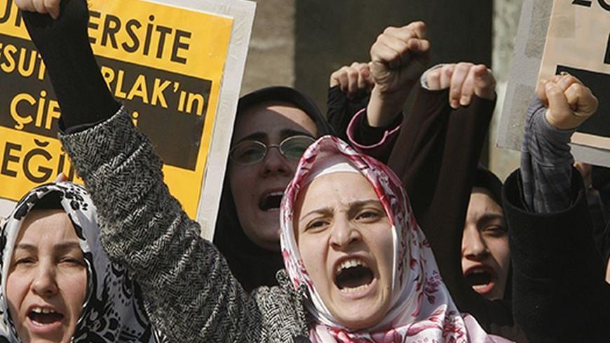 Demonstrators chant slogans during a protest in front of the Istanbul University in Istanbul February 29, 2008. Turkey has lifted a ban on students wearing Muslim headscarves but covered women are still marching on university gates demanding to be let in. REUTERS/Osman Orsal (TURKEY) - RTR1XQ76