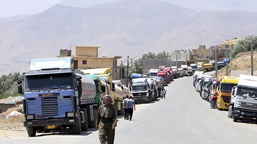 Fuel trucks are seen at Haj Umran border crossing with Iran, in northeastern Iraq July 20, 2010. Despite a pledge by Iraqi Kurdistan to crack down on the flow of fuel being smuggled to Iran, the only real impediment truck drivers say they face are long lines that force them to wait for days to cross. Picture taken July 20, 2010.   REUTERS/Azad Lashkari (IRAQ - Tags: POLITICS CRIME LAW ENERGY TRANSPORT IMAGES OF THE DAY) - RTR2GMNI