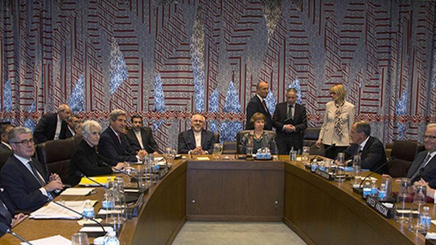 Seated at the table are French Foreign Minister Laurent Fabius (L), U.S. Secretary of State John Kerry (4th L), Iranian Foreign Minister Mohammad Javad Zarif (C), European Union foreign policy chief Catherine Ashton (4th R), Russian Foreign Minister Sergey Lavrov (3rd R) and British Foreign Secretary William Hague (R) during a meeting of the Foreign Ministers representing the permanent five member countries of the United Nations Security Council plus Germany on the sidelines of the UN General Assembly at th