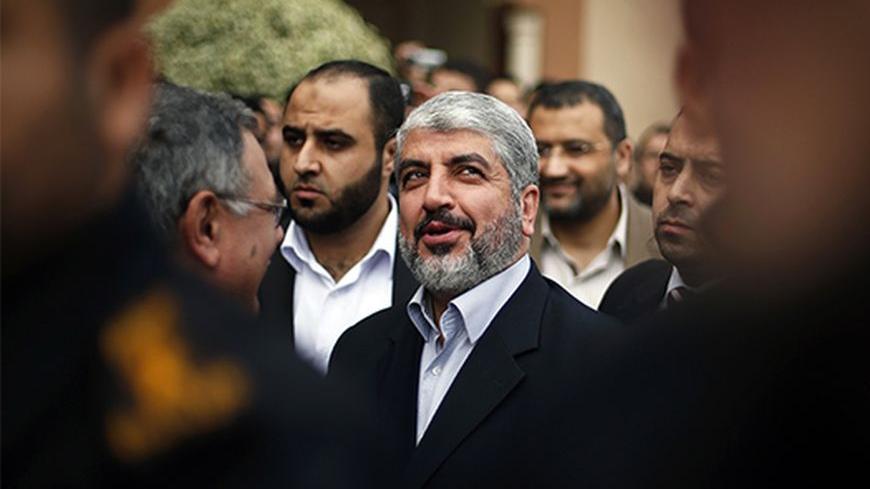 Hamas chief Khaled Meshaal (C) visits the Islamic University in Gaza City December 9, 2012. Hamas's vow to vanquish Israel after claiming "victory" in last month's Gaza conflict vindicates Israel's reluctance to relinquish more land to the Palestinians, Prime Minister Benjamin Netanyahu said on Sunday. Meshaal made a defiant speech before thousands of supporters in the Gaza Strip on Saturday, promising to take "inch-by-inch" all of modern-day Israel, which he said he would never recognise.      REUTERS/Suha