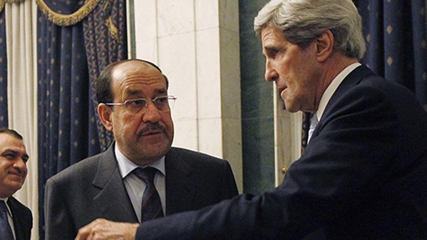 U.S. Secretary of State John Kerry (R) meets with Iraq's Prime Minister Nouri al-Maliki in Baghdad March 24, 2013. U.S. Secretary of State John Kerry made an unannounced visit to Iraq on Sunday and will urge Prime Minister Nuri al-Maliki to make sure Iranian flights over Iraq do not carry arms and fighters to Syria, a U.S. official said.  REUTERS/Jason Reed     (IRAQ - Tags: POLITICS TPX IMAGES OF THE DAY) - RTXXVJU