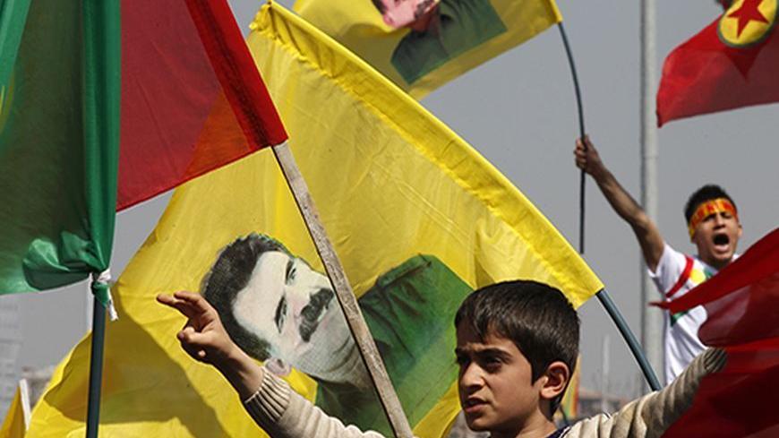 Demonstrators hold Kurdish flags and flags with portraits of jailed Kurdistan Workers Party (PKK) leader Abdullah Ocalan during a gathering to celebrate Newroz in the southeastern Turkish city of Diyarbakir March 21, 2013. Ocalan ordered his fighters on Thursday to cease fire and withdraw from Turkish soil as a step to ending a conflict that has killed 40,000 people, riven the country and battered its economy. Hundreds of thousands of Kurds, gathered in the regional centre of Diyarbakir, cheered and waved b
