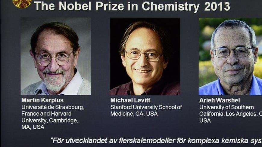 Photos of Martin Karplus, Michael Levitt and Arieh Warshel, the three laureates of the 2013 Nobel Prize for Chemistry, is seen on a screen during the announcement of the winners at the Royal Swedish Academy of Sciences in Stockholm October 9, 2013. Karplus, Levitt and Warshel won the 2013 Nobel Prize for chemistry for the development of multiscale models for complex chemical systems, the award-giving body said on Wednesday. REUTERS/Claudio Bresciani/TT News Agency  (SWEDEN - Tags: MEDIA SCIENCE TECHNOLOGY) 