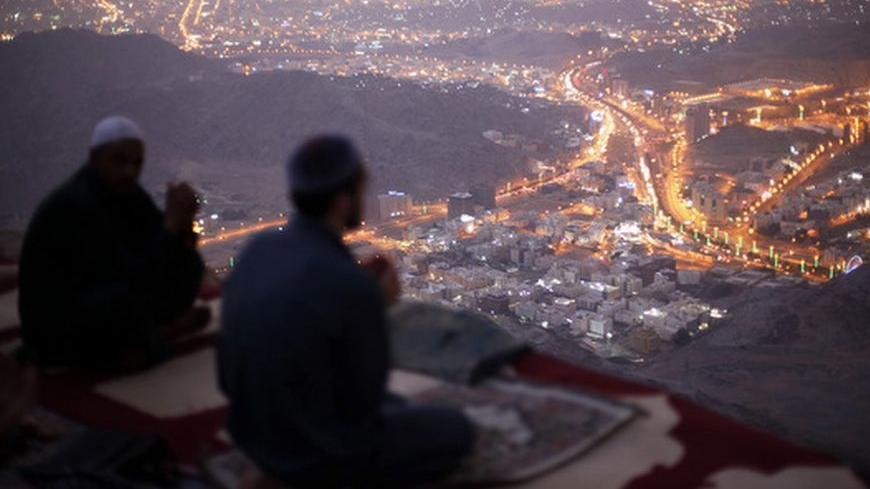 Muslim pilgrims pray atop Mount Thor in the holy city of Mecca ahead of the annual haj pilgrimage October 11, 2013. Mount Thor marks the start of the journey of the Prophet Mohammad and his companion Abu Bakr Al-Sadeeq from Mecca to Medina. It houses Thor cave where Prophet Mohammed is believed to have hid from the people of Quraish before his Hijra (migration) to Medina.  REUTERS/Ibraheem Abu Mustafa (SAUDI ARABIA - Tags: RELIGION) - RTX147ME