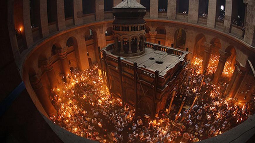 Worshippers hold candles as they take part in the Christian Orthodox Holy Fire ceremony at the Church of the Holy Sepulchre in Jerusalem's Old city May 4, 2013. REUTERS/Ammar Awad (JERUSALEM - Tags: RELIGION TPX IMAGES OF THE DAY) - RTXZA2B