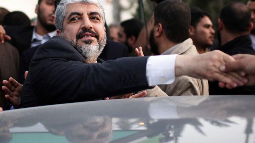 Hamas chief Khaled Meshaal shakes hands with a man as he leaves the Rafah border crossing in the southern Gaza Strip December 10, 2012. Hamas leader Meshaal ended his first visit to the Gaza Strip on Monday with a pledge his Islamist movement would strive to heal political rifts with Palestinian rivals who hold sway in the occupied West Bank. REUTERS/Ahmed Jadallah (GAZA - Tags: POLITICS) - RTR3BF9S