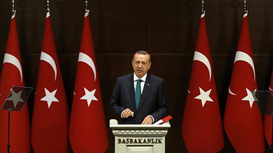 Turkish Prime Minister Tayyip Erdogan addresses the media in Ankara September 30, 2013. Turkey will end a ban that bars women from wearing the Islamic-style headscarf in state institutions, part of the government's long-awaited package of proposed human-rights reforms, Erdogan said on Monday in a major policy speech. The new rules will not apply to the judiciary or the military. Muslim but secular Turkey has long had tough restrictions on the garb worn by women working in state offices. Erdogan also announc