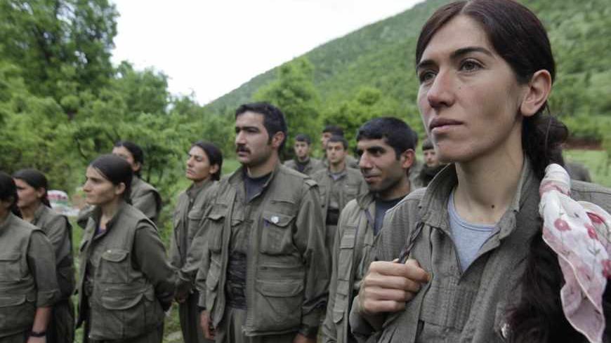 Kurdistan Workers Party (PKK) fighters stand in formation in northern Iraq May 14, 2013. The first group of Kurdish militants to withdraw from Turkey under a peace process entered northern Iraq on Tuesday, and were greeted by comrades from the Kurdistan Workers Party (PKK), in a symbolic step towards ending a three-decades-old insurgency. The 13 men and women, carrying guns and with rucksacks on their backs, arrived in the area of Heror, near Metina mountain on the Turkish-Iraqi border, a Reuters witness sa