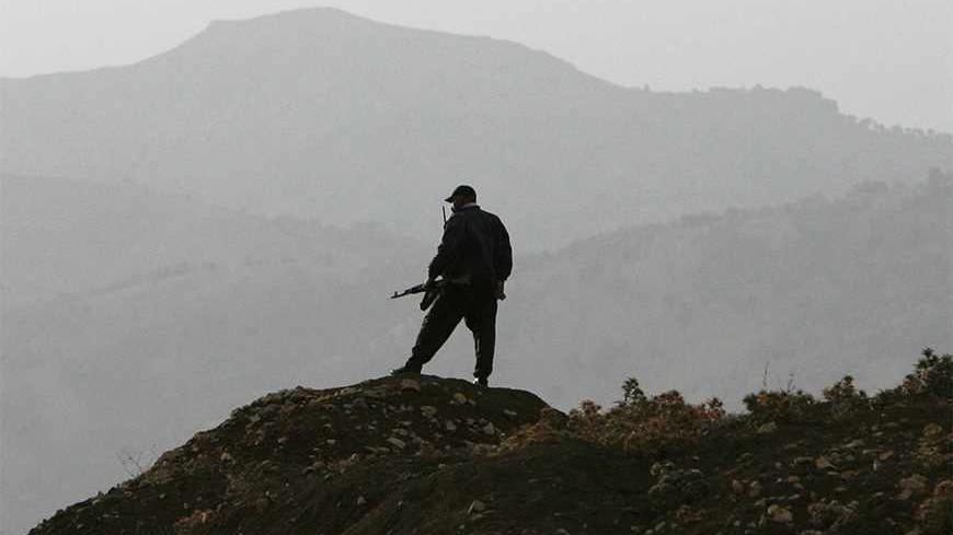 A Kurdish village guard stands top of the hill in the southeastern Turkish province of Sirnak October 26, 2007. President Abdullah Gul warned Kurdish rebels on Thursday that Turkey's patience was running out after Turkish forces said they had repelled a guerrilla attack near the Iraqi border.  REUTERS/Osman Orsal (TURKEY) - RTR1VC7F