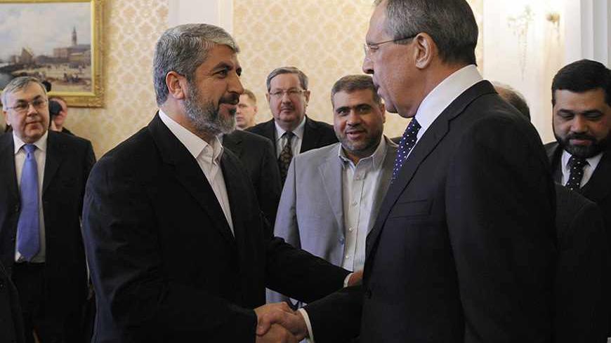 Hamas leader Khaled Meshaal (L) shakes hands with Russia's Foreign Minister Sergei Lavrov as they meet in Moscow February 8, 2010.  REUTERS/Sergei Karpukhin  (RUSSIA - Tags: POLITICS) - RTR29YP3