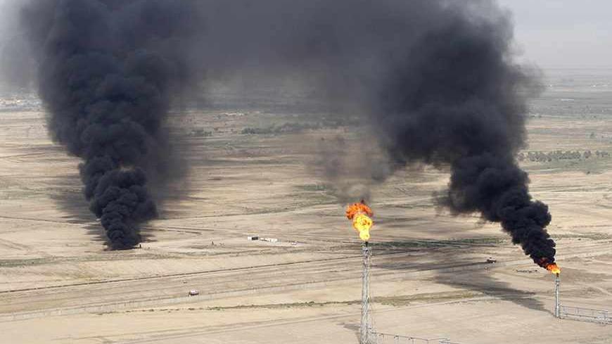 An aerial view of excess gas burning off at the al-Ahdab oil field in Wasit province September 23, 2011. Chinese company, the China National Petroleum Corporation has begun operations at the Al-Ahdab oil field in Iraq, according to news reports. Picture taken September 23, 2011. REUTERS/Mohammed Ameen (IRAQ - Tags :POLITICS BUSINESS - Tags: POLITICS ENERGY BUSINESS) - RTR2RRJ2