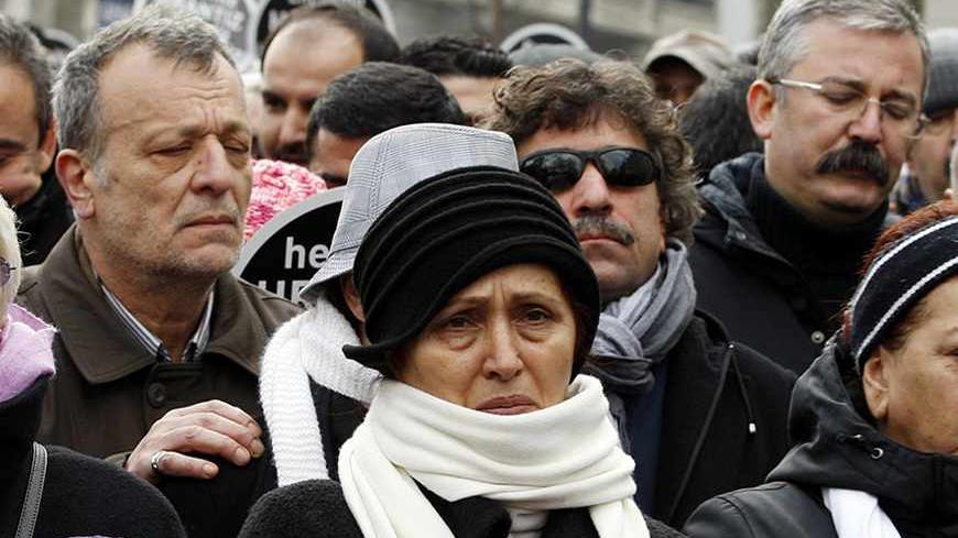 Rakel Dink (C), widow of slain Turkish-Armenian editor Hrant Dink, walks towards office the Agos newspaper office during a demonstration to mark the fifth death anniversary of her husband in Istanbul January 19, 2012. A man was sentenced to life in prison in Turkey on Tuesday for the 2007 killing of prominent Turkish-Armenian journalist Dink in a verdict that drew criticism from rights groups for failing to explore alleged complicity of state officials. Editor of the bilingual Turkish-Armenian weekly Agos a
