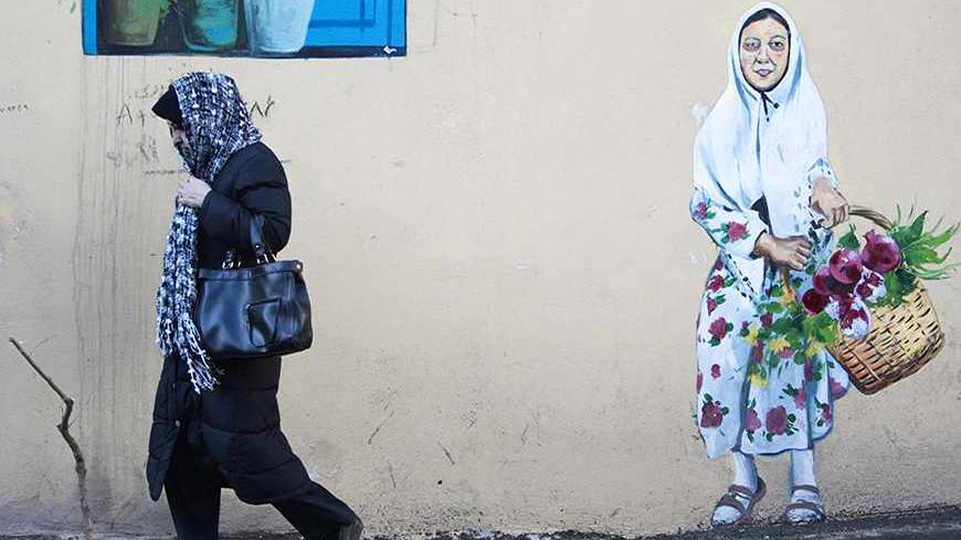 EDITORS' NOTE: Reuters and other foreign media are subject to Iranian restrictions on leaving the office to report, film or take pictures in Tehran.

A woman walks on a sidewalk in central of Tehran March 3, 2012. REUTERS/Raheb Homavandi  (IRAN - Tags: SOCIETY TPX IMAGES OF THE DAY) - RTR2YRLH