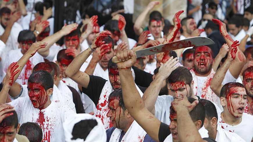 Shi'ite Muslim men bleed as they gash their foreheads with swords and beat themselves during a ceremony marking Ashura in Nabatieh, southern Lebanon November 25, 2012. Shi'ite mourners beat themselves during Ashura with steel-tipped flails or slash their bodies with knives to mark the death anniversary of Imam Hussein, a grandson of the Prophet Mohammad, who was killed during a battle in A.D. 680 in Kerbala, a city in modern-day Iraq. REUTERS/Sharif Karim  (LEBANON - Tags: RELIGION) SOCIETY) - RTR3AURP