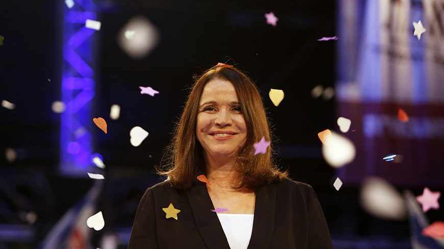 Confetti drops as Labour party leader Shelly Yachimovich stands on stage during an event to mark the end of the party campaign in Tel Aviv January 17, 2013. Opinion polls have shown Labour, which ruled Israel for decades but now holds only eight seats in parliament, bouncing back to second place behind Likud under new leader Yachimovich. REUTERS/Baz Ratner (ISRAEL - Tags: POLITICS ELECTIONS) - RTR3CKNE