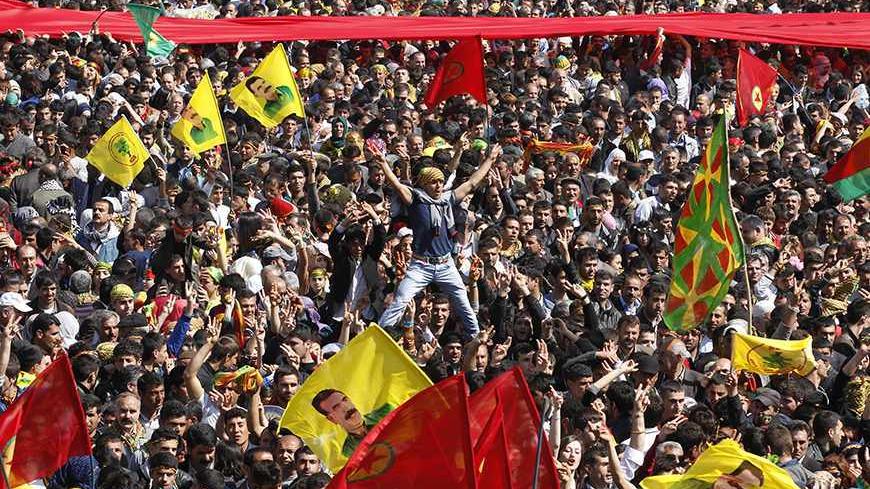 Demonstrators hold Kurdish flags and flags with portraits of the jailed Kurdistan Workers Party (PKK) leader Abdullah Ocalan during a gathering to celebrate Newroz in the southeastern Turkish city of Diyarbakir March 21, 2013. Ocalan ordered his fighters on Thursday to cease fire and withdraw from Turkish soil as a step to ending a conflict that has killed 40,000 people, riven the country and battered its economy. Hundreds of thousands of Kurds, gathered in the regional centre of Diyarbakir, cheered and wav