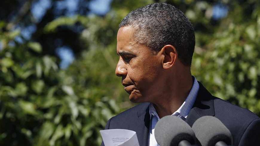 U.S. President Barack Obama walks out after speaking about the violence in Egypt while at his rental vacation home on the Massachusetts island of Martha's Vineyard in Chilmark August 15, 2013.      REUTERS/Larry Downing  (UNITED STATES - Tags: POLITICS) - RTX12MDQ