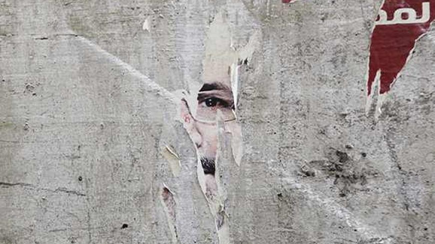 Remnants of a poster of ousted Egyptian President Mohamed Mursi are pictured on a wall on a street in Cairo August 25, 2013. Egypt's army-backed government shortened a night-time curfew by two hours on Saturday, 10 days after imposing it during a fierce crackdown on Muslim Brotherhood protesters in Cairo. Authorities imposed the curfew on August 14 when police destroyed Brotherhood protest camps in Cairo set up to demand the reinstatement of Mursi. REUTERS/Muhammad Hamed (EGYPT - Tags: POLITICS TPX IMAGES O