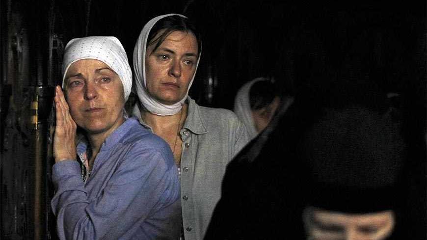 Orthodox Christian worshippers gather before the start of a procession outside Jerusalem's Old City September 5, 2013. About two hundred Orthodox Christians took part in an annual procession in which an icon of the Virgin Mary is carried from a church at the foot of the Mount of Olives believed by Christians to mark the tomb of the Virgin Mary back to the Church of the Holy Sepulchre in Jerusalem's Old City. REUTERS/Ammar Awad (JERUSALEM - Tags: RELIGION) - RTX137SV