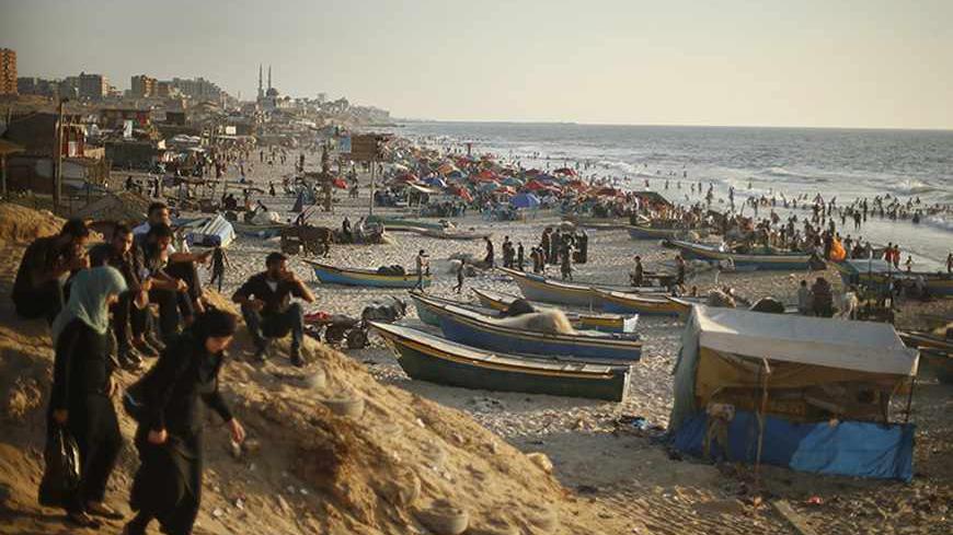 Palestinians enjoy the weather on the beach in Gaza City August 23, 2013. Gaza's sandy beach is a favourite spot for locals to relax, especially as most residents cannot afford holidays outside the enclave. Picture taken August 23, 2013. REUTERS/Mohammed Salem (GAZA - Tags: POLITICS SOCIETY TPX IMAGES OF THE DAY) - RTX145VO