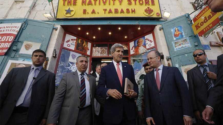 U.S. Secretary of State John Kerry walks out after shopping for souvenirs at "The nativity Store" in Manger Square, Bethlehem, November 6, 2013. Kerry was in Bethlehem to promote USAID's assistance in improving infrastructure projects in the West Bank.   REUTERS/Jason Reed   (WEST BANK - Tags: POLITICS) - RTX15284