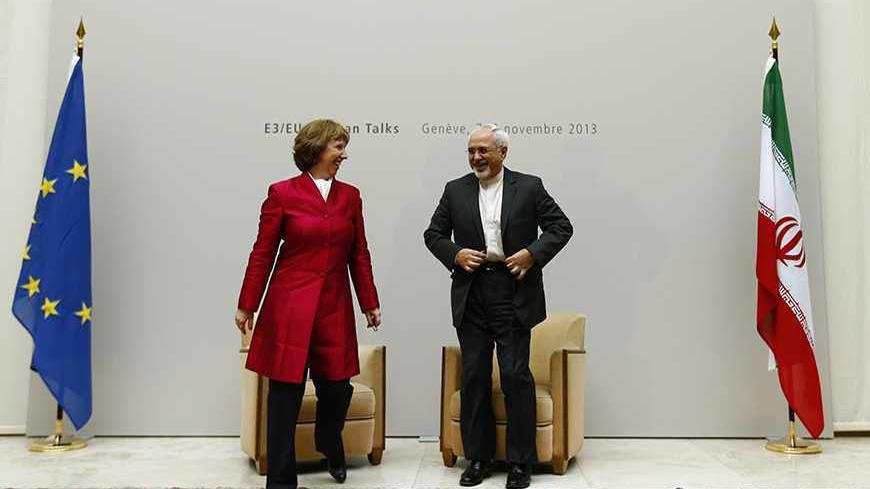 European Union foreign policy chief Catherine Ashton (L) leaves with Iranian Foreign Minister Mohammad Javad Zarif after a photo opportunity before the start of two days of closed-door nuclear talks at the United Nations European headquarters in Geneva November 7, 2013.  REUTERS/Denis Balibouse (SWITZERLAND - Tags: POLITICS) - RTX153PA