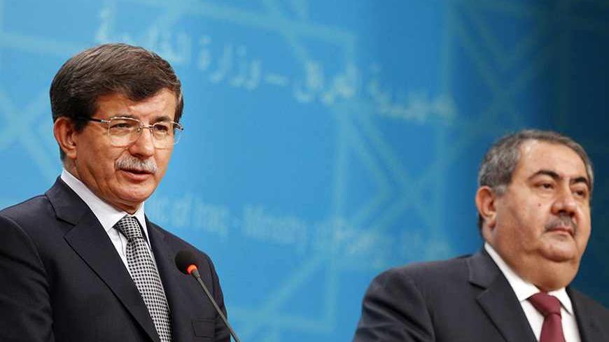 Turkish Foreign Minister Ahmet Davutoglu addresses the media during a joint news conference with Iraq's Foreign Minister Hoshiyar Zebari at the Foreign Ministry headquarters in Baghdad, November 10, 2013.  REUTERS/Thaier Al-Sudani (IRAQ - Tags: POLITICS) - RTX157TO