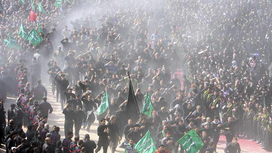 Shi'ite pilgrims run between the Imam Hussein and Imam Abbas shrines as part of a ritual of the Ashura ceremony in Kerbala, 80 km (50 miles) southwest of Baghdad, November 14, 2013. During Ashura, Shi'ite Muslims commemorate the slaying of Prophet Muhammad's grandson Hussein in Kerbala in 680 AD. The most important day in the Shi'ite calendar, Ashura has become a show of strength in Iraq for a majority whose public worship was repressed by former dictator Saddam Hussein.  REUTERS/Mushtaq Muhammed (IRAQ - Ta