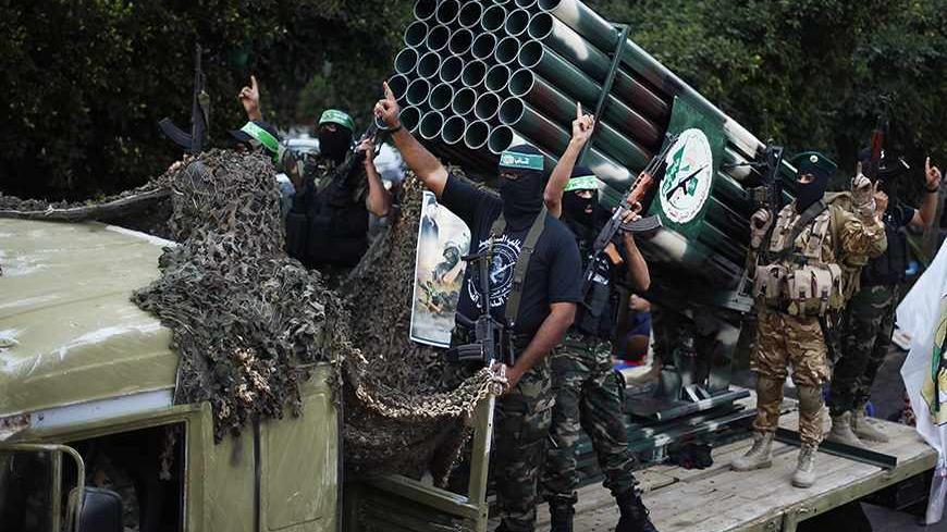 Palestinian Hamas militants take part in a military parade marking the first anniversary of the eight-day conflict with Israel, in Gaza City November 14, 2013. Eight days of Israeli air strikes on Gaza and cross-border Palestinian rocket attacks in November last year ended in an Egyptian-brokered truce agreement calling on Israel to ease restrictions on the territory.  REUTERS/Suhaib Salem (GAZA - Tags: POLITICS ANNIVERSARY CONFLICT MILITARY) - RTX15DDP