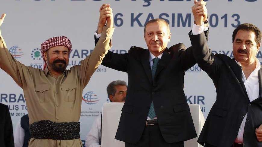 Turkey's Prime Minister Tayyip Erdogan, Kurdish poet and singer Sivan Perwer (L), who had fled Turkey in the 1970s,  and Turkish singer Ibrahim Tatlises (R) greet people during a ceremony in Diyarbakir November 16, 2013. The president of Iraqi Kurdistan called on Turkey's Kurds to back a flagging peace process with Ankara on Saturday, making his first visit to southeastern Turkey in two decades in a show of support for Prime Minister Tayyip Erdogan. Masoud Barzani's trip to Diyarbakir, the main city in Turk