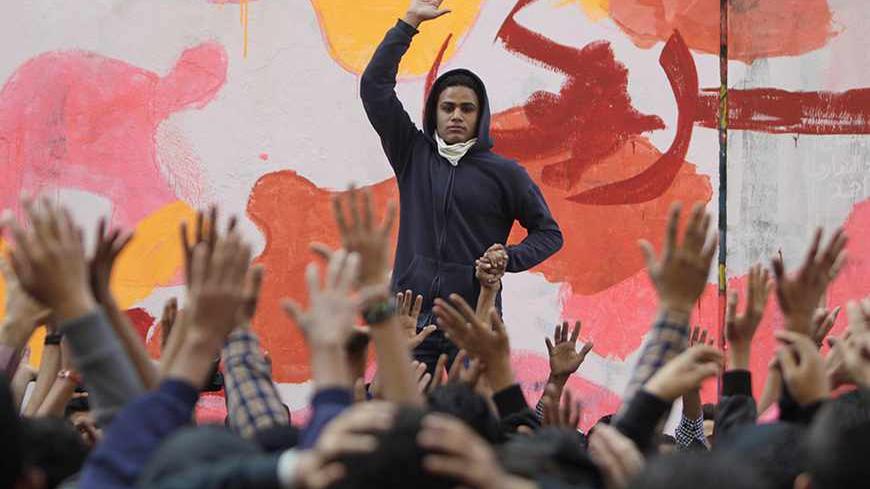 An anti-military protester leads chanting during a rally to commemorate the second anniversary of the deaths of 42 people in clashes with security forces on Mohamed Mahmoud Street, near Tahrir Square in Cairo November 19, 2013. REUTERS/Mohamed Abd El Ghany (EGYPT - Tags: POLITICS CIVIL UNREST) - RTX15JW1