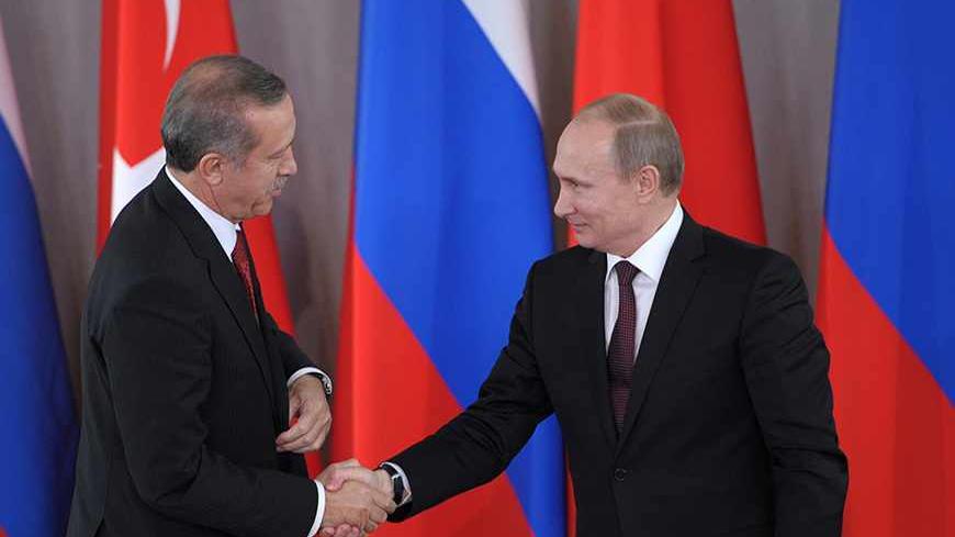 Russian President Vladimir Putin (R) shakes hands with Turkish Prime Minister Tayyip Erdogan in Strelna near St. Petersburg, November 22, 2013. Putin said on Friday Western states must persuade the Syrian opposition to attend talks with President Bashar al-Assad's government which he said should take place as soon as possible.  REUTERS/Aleksey Nikolskyi/RIA Novosti/Kremlin (RUSSIA - Tags: POLITICS CONFLICT) 

ATTENTION EDITORS - THIS IMAGE HAS BEEN SUPPLIED BY A THIRD PARTY. IT IS DISTRIBUTED, EXACTLY AS RE