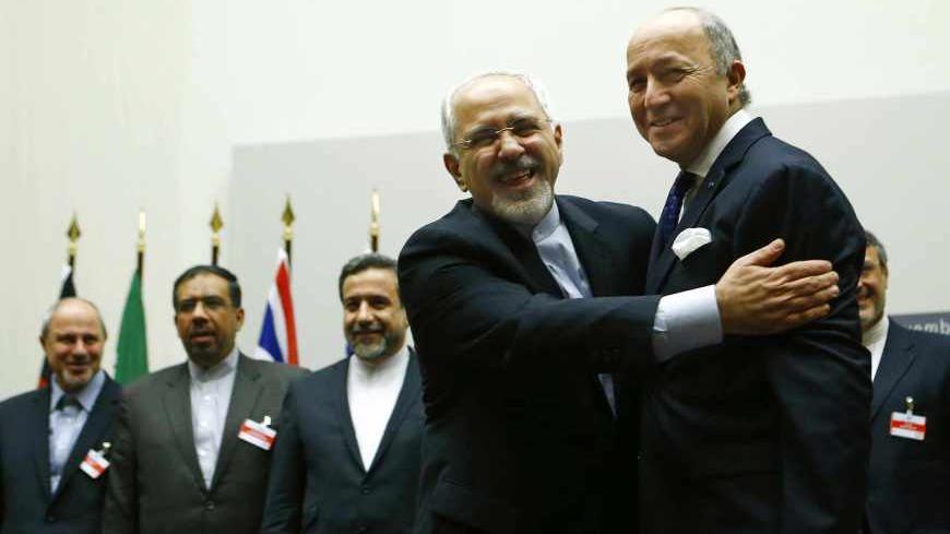Iranian Foreign Minister Mohammad Javad Zarif (2nd R) hugs French Foreign Minister Laurent Fabius after a ceremony at the United Nations in Geneva November 24, 2013.  Iran and six world powers reached a breakthrough agreement early on Sunday to curb Tehran's nuclear programme in exchange for limited sanctions relief, in a first step towards resolving a dangerous decade-old standoff. REUTERS/Denis Balibouse (SWITZERLAND - Tags: POLITICS ENERGY TPX IMAGES OF THE DAY) - RTX15QNB