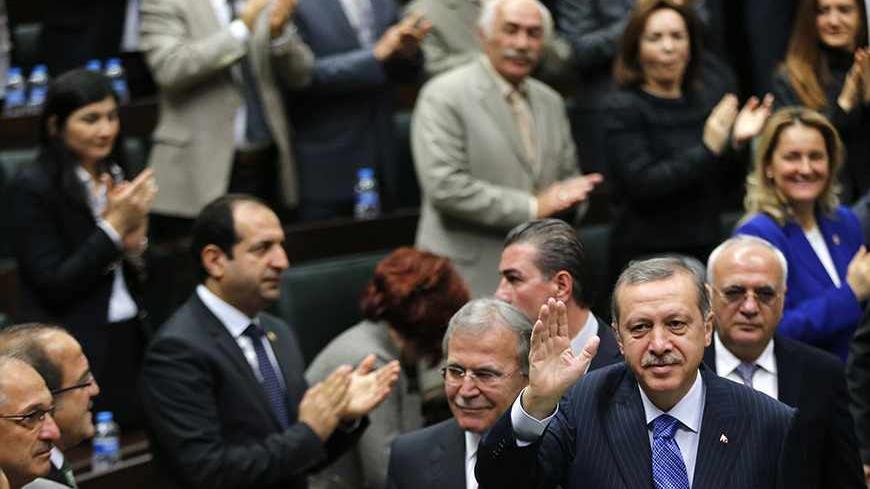 Turkey's Prime Minister Tayyip Erdogan greets members of parliament from his ruling AK Party (AKP) during a meeting at the Turkish parliament in Ankara November 26, 2013. REUTERS/Umit Bektas (TURKEY  - Tags: POLITICS) - RTX15TOG