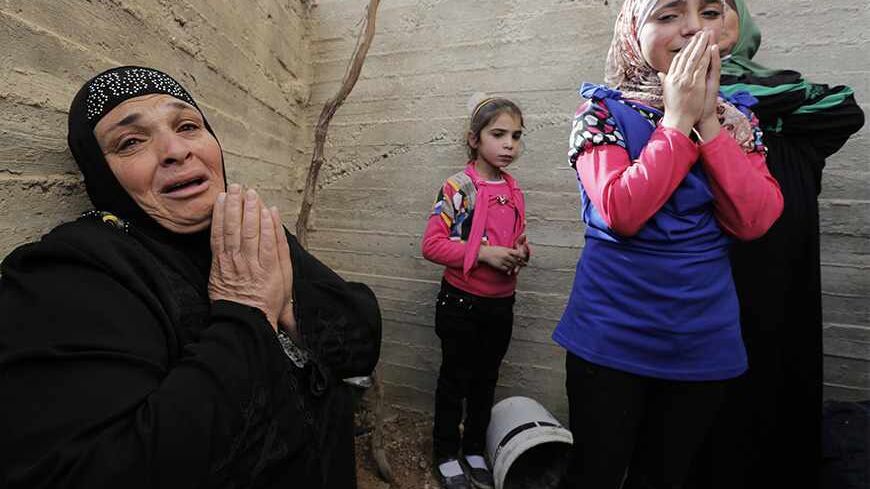 Women and girls mourn during the funerals of Palestinian Moussa Makhamra and Khalid al-Najjar in the West Bank village of Yatta, near Hebron November 27, 2013. Israeli security officials said their forces killed three Palestinian militants, including Makhamra and al-Najjar, on Tuesday who were part of an al Qaeda-linked network in the West Bank. REUTERS/Ammar Awad (WEST BANK - Tags: POLITICS CIVIL UNREST TPX IMAGES OF THE DAY) - RTX15UU4