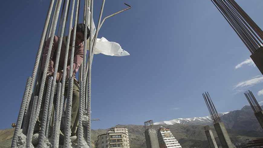 EDITORS' NOTE: Reuters and other foreign media are subject to Iranian restrictions on their ability to report, film or take pictures in Tehran. 

A construction worker uses a jack hammer to remove support pillars for the final floor of a high rise building in north Tehran April 15, 2010. The municipality said they had built one too many floors than their permit allowed.  President Mahmoud Ahmadinejad has asked 5 million Tehranis to evacuate the capital since they know their sprawling metropolis is due for a